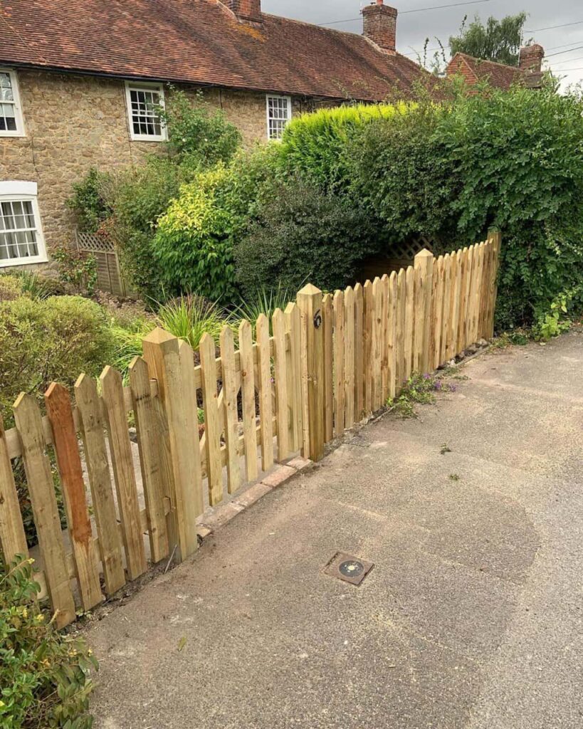 This is a photo of a picket fence and picket gate installed by Fast Fix Fencing Ely