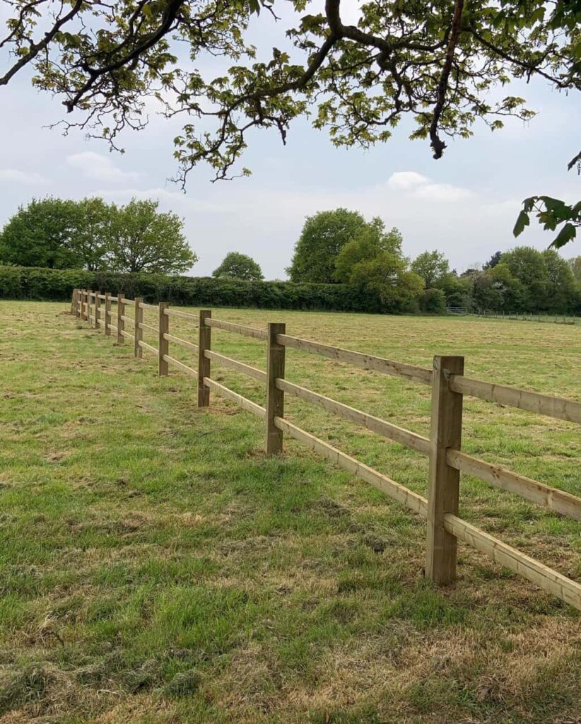 This is a photo of a post and rail fence installed in a field by Fast Fix Fencing Ely